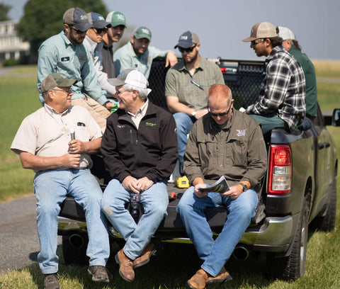 Agronomy team on the back of a truck tailgate