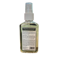 A clear plastic spray bottle filled with a pale yellow-green liquid, shown from the back with a white spray top and a large black product information label. The brand name 'Beach of California' is partially visible at the top of the label.