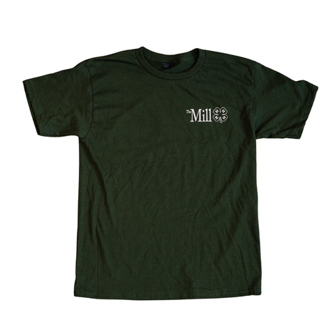 A green shirt with a 'The Mill' logo next to a clover on a white background. 