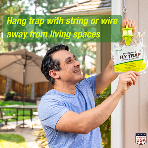 Rescue outdoor disposable fly trap with water-activated lure for effective fly control, shown hanging outdoors in the image.