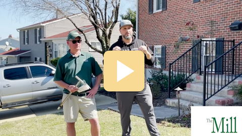 Two men standing in front of a house with a 'The Mill' logo in the corner.