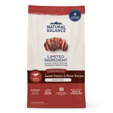 A bag of Natural Balance Reserve Sweet Potato & Bison Recipe adult dog food, grain free, single animal protein, with real Bison. The packaging is cream and dark red with a photo of sliced grilled meat in the center.
