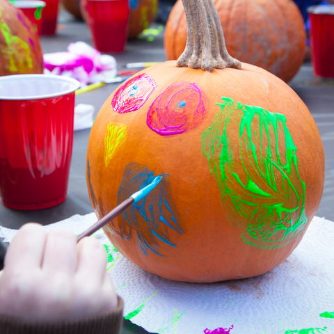 Painting a face on a pumpkin
