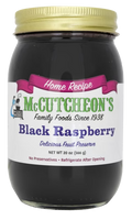 Jar of McCutcheon's Seedless Black Raspberry Preserves with a label showing fresh black raspberries and the product name.