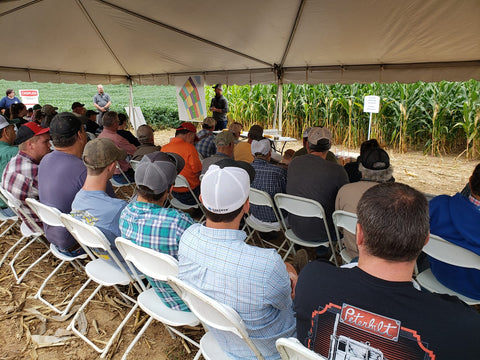 Mill's Crop Showcase tent stop with farmers listening to field observations
