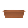 Bloem Dayton 27-inch terra cotta recycled plastic rectangle deck box planter with lush green plants and flowers.
