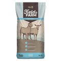 Field & Farm goat feed bag by Kent Feeds, 50 lb, showing textured goat and sheep feed in a clear bag with farm background.