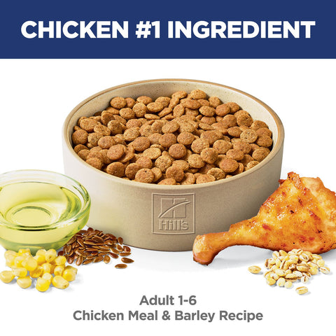 Bag of Hill's Science Diet Adult Chicken & Barley Recipe Dry Dog Food with a scoop of kibble and a dog in the background.