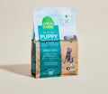 Open Farm grain-free puppy dog food with chicken and salmon kibble, showing a bowl of the dog food recipe.