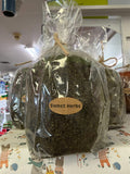 Americana Vintage Candle in Sweet Herbs scent, featuring a rustic jar with a lit candle and fresh herbal accents.