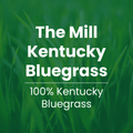 A green grass background with large white text reading 'The Mill Kentucky Bluegrass' and smaller text below reading '100% Kentucky Bluegrass.'.