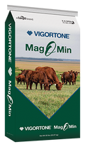 Vigortone Mag O Min with Altosid livestock supplement mineral block showing mineral content and branding in a farm setting.