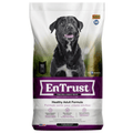 A bag of EnTrust Healthy Adult Formula dog food, featuring a black and white dog on the front of the packaging, with a white, purple, and green design.