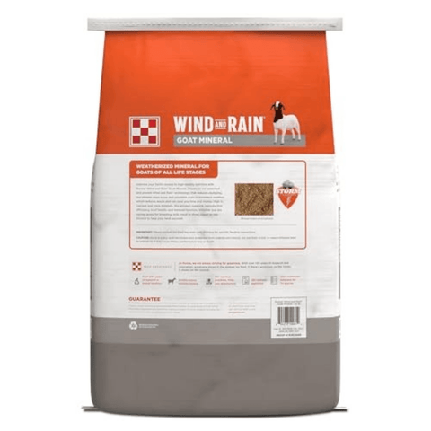 A bag of Wind and Rain Goat Mineral dry dog food, featuring a white bag with a bright orange top section and a gray bottom section.