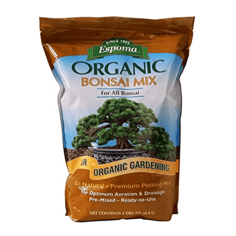 Statesman Espoma Organic Moisture Potting Mix for potted plants, 8 Qt, showing rich soil with gardening tools and healthy plants.