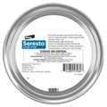 Elanco Seresto Dog flea and tick collar packaging with a circular silv er outlining a white informational label.  In front on a white background.