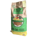 A bag of Homestead Harvest Non-GMO Feeds, featuring a brown paper bag with a green and yellow label, set against a plain white background.