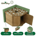 A wooden birdhouse with a green frame and lid, decorated with a white floral pattern on the top. The image includes feature callouts at the bottom highlighting air vents, a clean-out door, and solid wood construction, with the Wild Wings brand logo in the upper left.