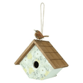 Birdhouse with a bird perched on top against a white background