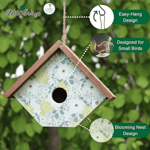 A hanging birdhouse with a floral print panel and wooden frame, shown outdoors against green leaves with callout graphics explaining its easy-hang design, suitability for small birds, and blooming nest design.