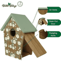 A wooden birdhouse with a sage green roof, floral-patterned brown front panel, and open front door. Callout callouts point to the roof, air vents, clean-out door, and fledgling kerfs.