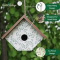 Birdhouse with green leaf pattern, hanging design, and ivy perch feature on a blurred green background.