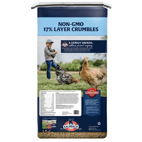 A bag of K&H Valhalla Non-GMO 17% Layer Crumbles chicken feed, featuring a dark blue and light blue design with a photo of chickens and a farmer on the front.