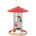 A hummingbird feeder with a red metal roof, clear glass body, white base, wooden ring, and a printed hummingbird and flower design on the front.