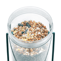 Clear container filled with birdseed on a white background
