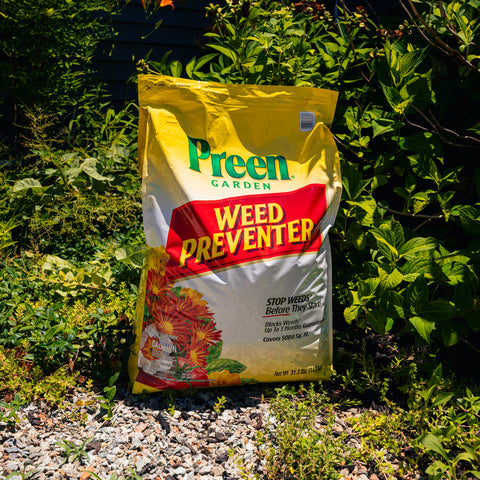 Bag of Preen Garden Weed Preventer in a garden setting