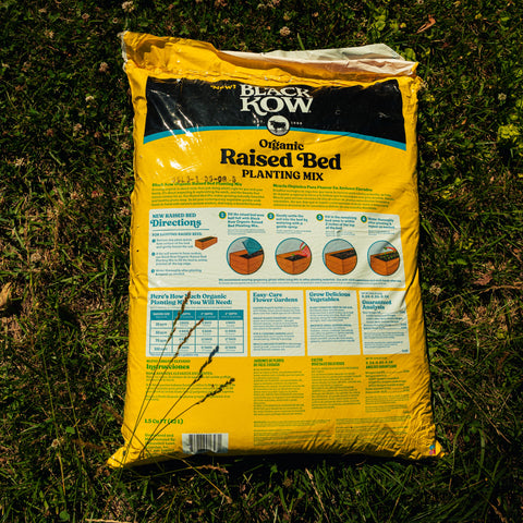 Bag of Black Kow Raised Bed Planting Mix on grass