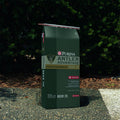 Purina Antler Advantage Deer 20 food package with green bushes in the background