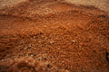 Close-up of red sand or soil with a blurred background