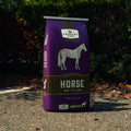 Bag of Purina Country Acres Horse Sweet Feed 12% in a 50 lb bag, showing the horse feed packaging and branding.