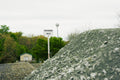 Pile of crushed rock with a sign labeled 'Crusher Run' in the background.