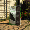 Nutrena Stock & Stable 12% textured horse feed in a bag, featuring colorful packaging and textured grain mix for horses.