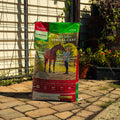 Nutrena SafeChoice Special Care horse feed bag showing the product label and branding on a farm setting.