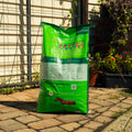 Nutrena SafeChoice Maintenance Horse Feed bag with a horse grazing in a stable setting.