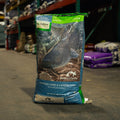 A bag of Nutrena Nature's Canvas Floating Pond & Catfish Food in a warehouse
