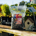 The Mill Cardinal Blend bird seed in a clear bag, showing colorful mixed bird food for attracting cardinals and songbirds.