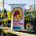 Birds Luv 'Em Premium Wild Bird Seed Blend in a bag, showing colorful seed mixture for wild birds on a natural background.