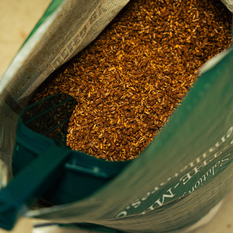 The Mill 11% Sweet Horse Feed bag showing colorful packaging with horse feed product details and branding.