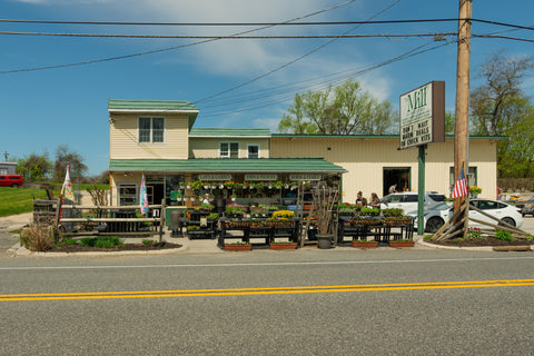 Storefront with outdoor seating area on a sunny day