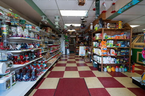 Interior of a convenience store with shelves stocked with various products.