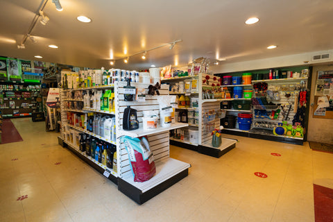 Store interior with shelves stocked with products and feed