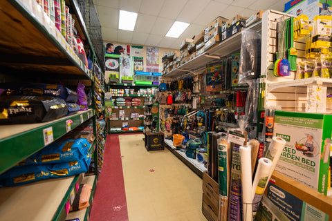 Narrow aisle in a store with shelves stocked with various products