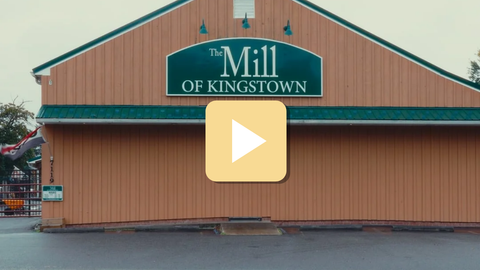 Building with 'The Mill of Kingstown' sign and a play button overlay