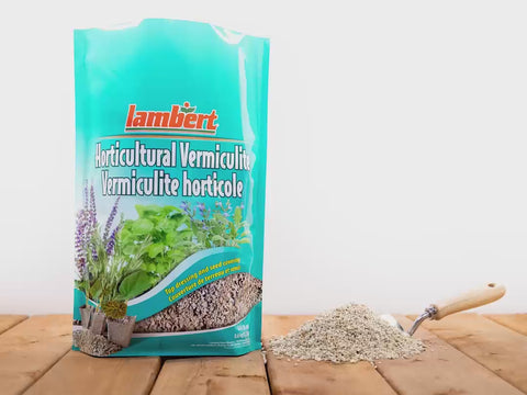 Scooping vermiculite from a bag and dropping it on a table