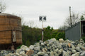 R4 signpost among rocks with a large cylindrical tank in the background