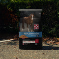 Purina RepleniMash horse feed in a bag, designed for hydration and recovery, featuring the Purina brand logo on the packaging.